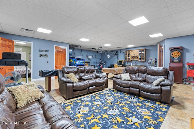 living room with a paneled ceiling