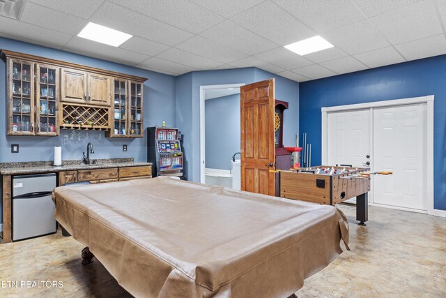 rec room with a drop ceiling, wet bar, and billiards