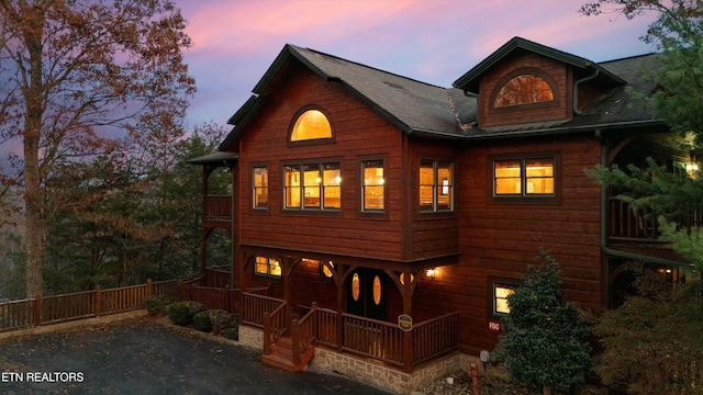 view of back house at dusk