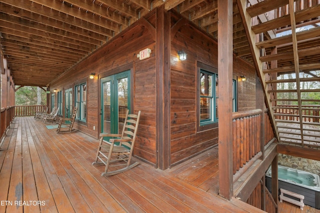 deck with a porch and french doors