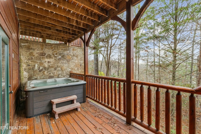 wooden deck featuring a hot tub