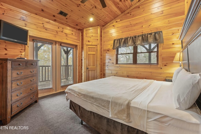 bedroom featuring ceiling fan, dark colored carpet, wood walls, lofted ceiling, and wood ceiling