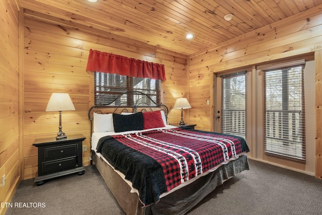 carpeted bedroom featuring wood ceiling and wooden walls