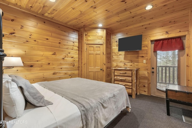 bedroom with wooden walls, carpet floors, and wood ceiling