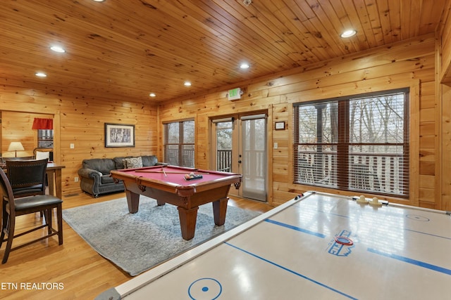 recreation room with wood walls, light wood-type flooring, and pool table