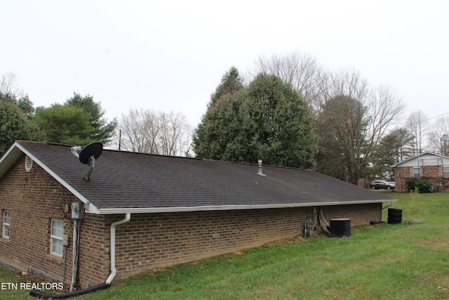 view of home's exterior with central air condition unit and a lawn