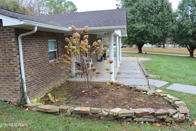 view of side of home featuring a yard