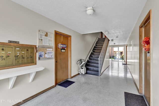 hallway with a textured ceiling