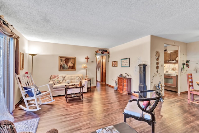 living room with hardwood / wood-style flooring and a textured ceiling