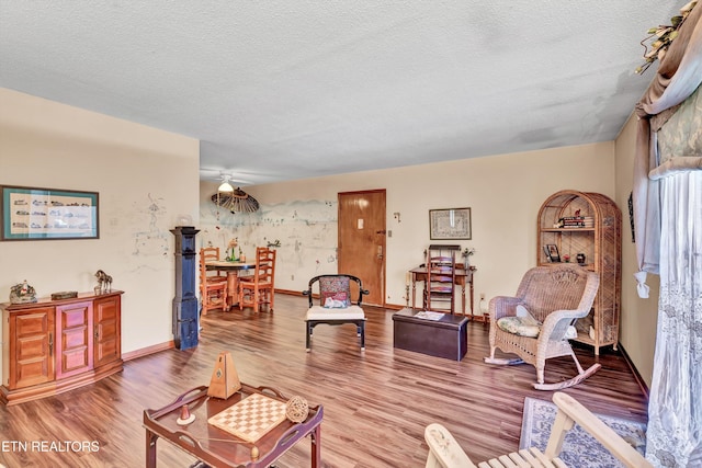 living room featuring a textured ceiling and light wood-type flooring