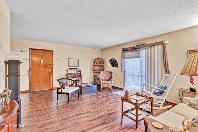 living room with wood-type flooring and a textured ceiling