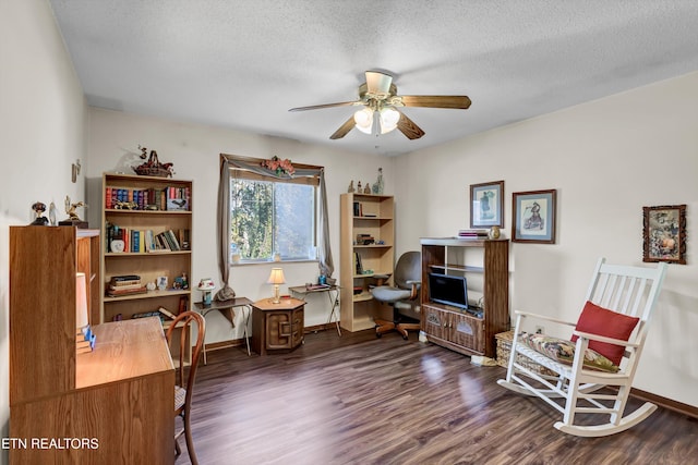 office space with a textured ceiling, ceiling fan, and dark wood-type flooring