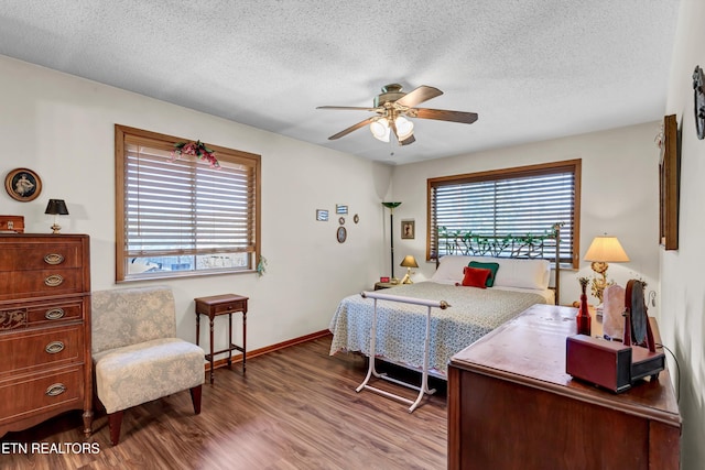 bedroom featuring hardwood / wood-style flooring, ceiling fan, and a textured ceiling