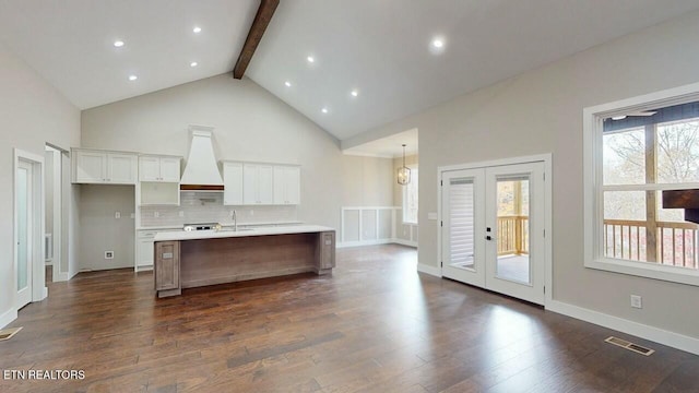 kitchen featuring beamed ceiling, visible vents, custom range hood, and dark wood-style flooring