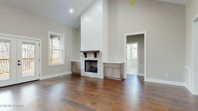 unfurnished living room featuring dark wood-style floors, high vaulted ceiling, and french doors