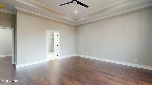 spare room featuring dark wood-style floors, baseboards, and ornamental molding