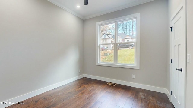 unfurnished room featuring crown molding, dark wood-type flooring, baseboards, visible vents, and a ceiling fan