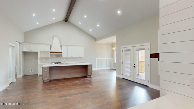 kitchen with white cabinetry, french doors, dark wood-type flooring, beamed ceiling, and custom exhaust hood