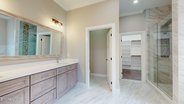 full bath featuring a stall shower, marble finish floor, crown molding, and a sink