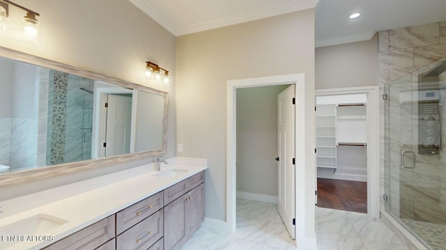 bathroom with marble finish floor, ornamental molding, a sink, and a shower stall