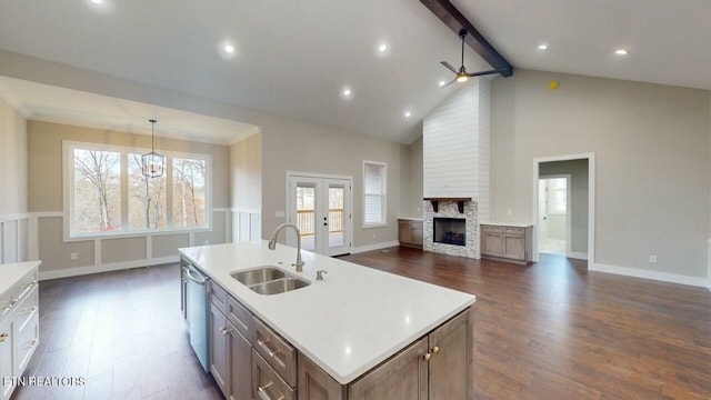 kitchen featuring dark wood-type flooring, a sink, french doors, and open floor plan
