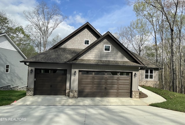 exterior space with driveway, board and batten siding, and roof with shingles