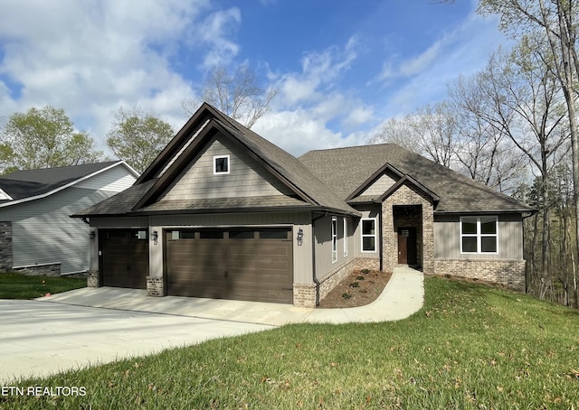 craftsman house featuring a garage, concrete driveway, brick siding, a front lawn, and roof with shingles
