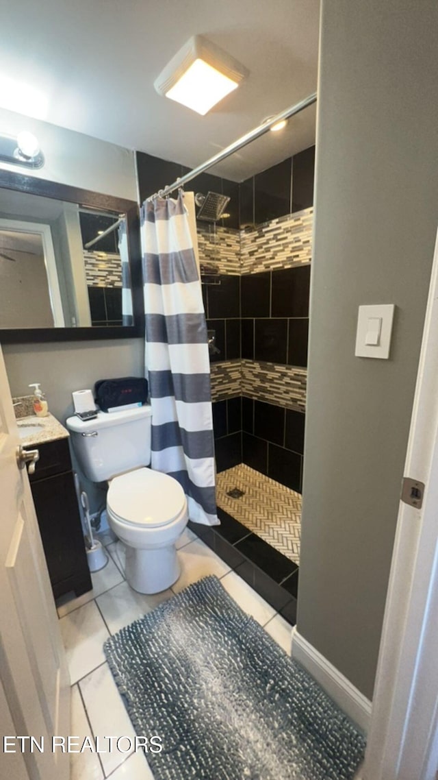 bathroom with tile patterned floors, toilet, vanity, and a shower with shower curtain