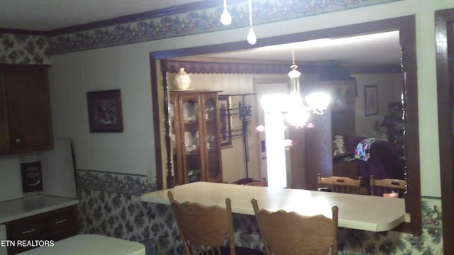 dining room with a chandelier and crown molding