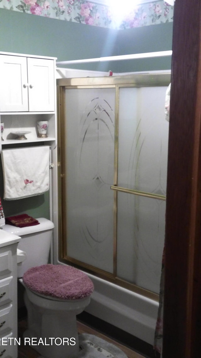 full bathroom with toilet, vanity, and combined bath / shower with glass door