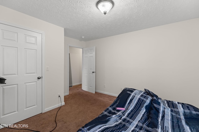 carpeted bedroom with a textured ceiling