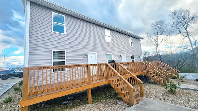 rear view of house with a wooden deck