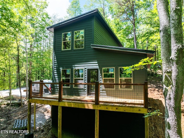 rear view of property featuring a deck