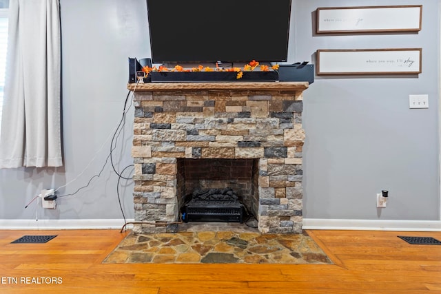 room details with hardwood / wood-style floors and a fireplace