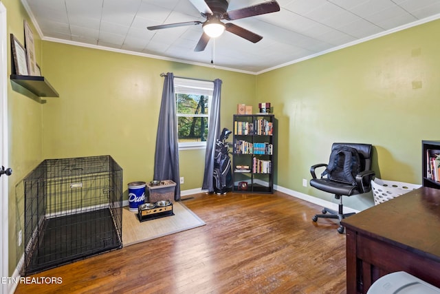 home office featuring hardwood / wood-style flooring, ceiling fan, and crown molding