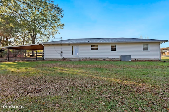 back of property featuring a yard, central AC unit, and a carport