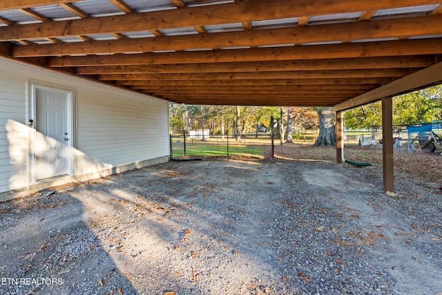 view of parking / parking lot featuring a carport