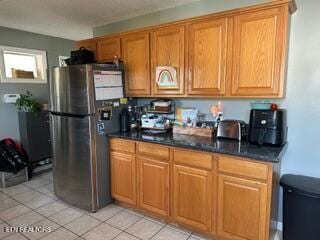 kitchen with stainless steel fridge and light tile patterned flooring