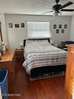 bedroom with ceiling fan and dark hardwood / wood-style flooring