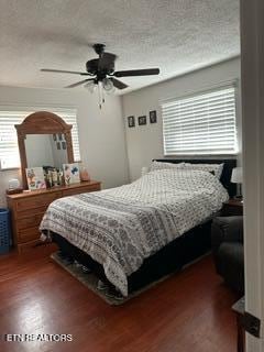 bedroom with a textured ceiling, dark hardwood / wood-style floors, and ceiling fan