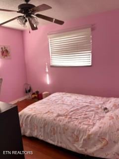 bedroom featuring hardwood / wood-style floors and ceiling fan