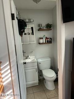 bathroom featuring tile patterned floors, vanity, and toilet