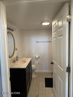 bathroom featuring tile patterned floors, vanity, and toilet