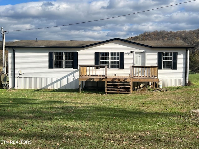 back of house with a yard and a wooden deck