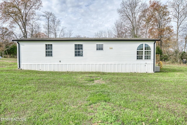 view of side of home featuring a lawn