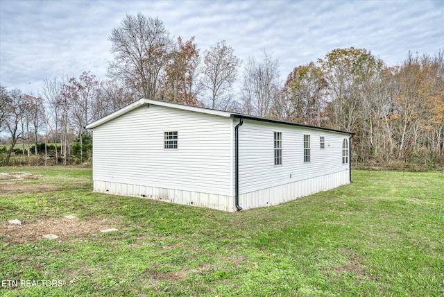 view of side of property with a yard