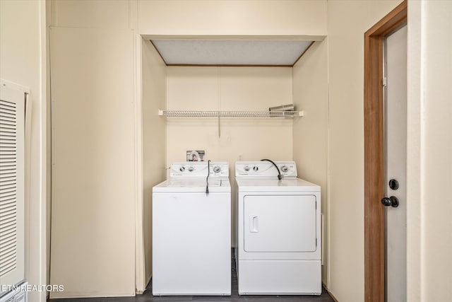 washroom with independent washer and dryer and wood-type flooring