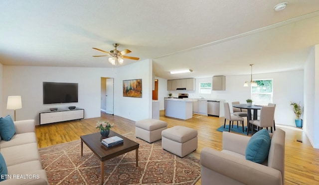 living room featuring ceiling fan and light hardwood / wood-style flooring