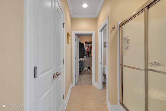 hall featuring light tile patterned floors and ornamental molding