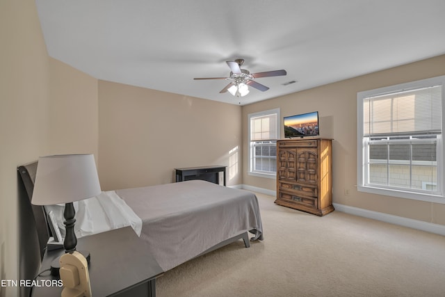 bedroom featuring light colored carpet and ceiling fan